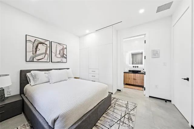 a bedroom with a bed and a view of bathroom