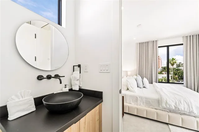 a bedroom with a bed and a mirror