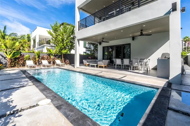 a view of a swimming pool with outdoor seating