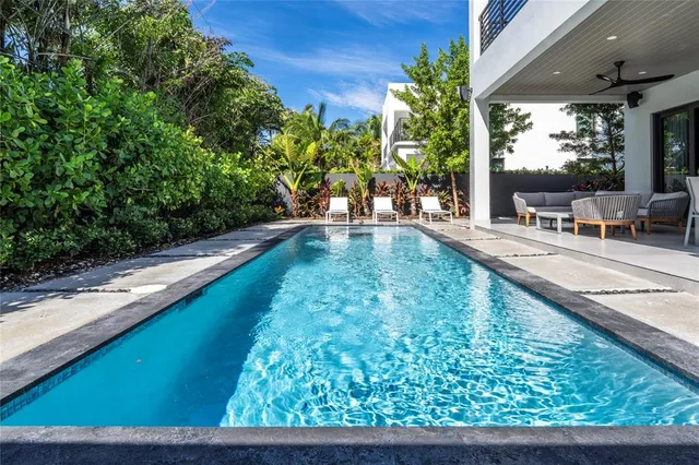 a view of swimming pool with outdoor seating