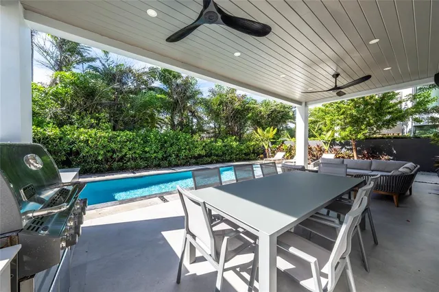 a view of an outdoor dining space with a table and chairs