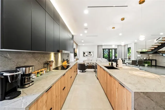 a large kitchen with stainless steel appliances lots of counter space and a sink