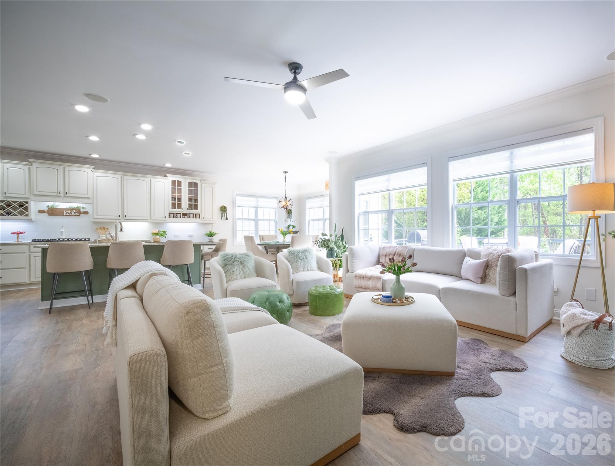 12058 Pelican Court Tega Cay, SC 29708 - Photo 12 of 43 a living room with furniture and a large window with kitchen view