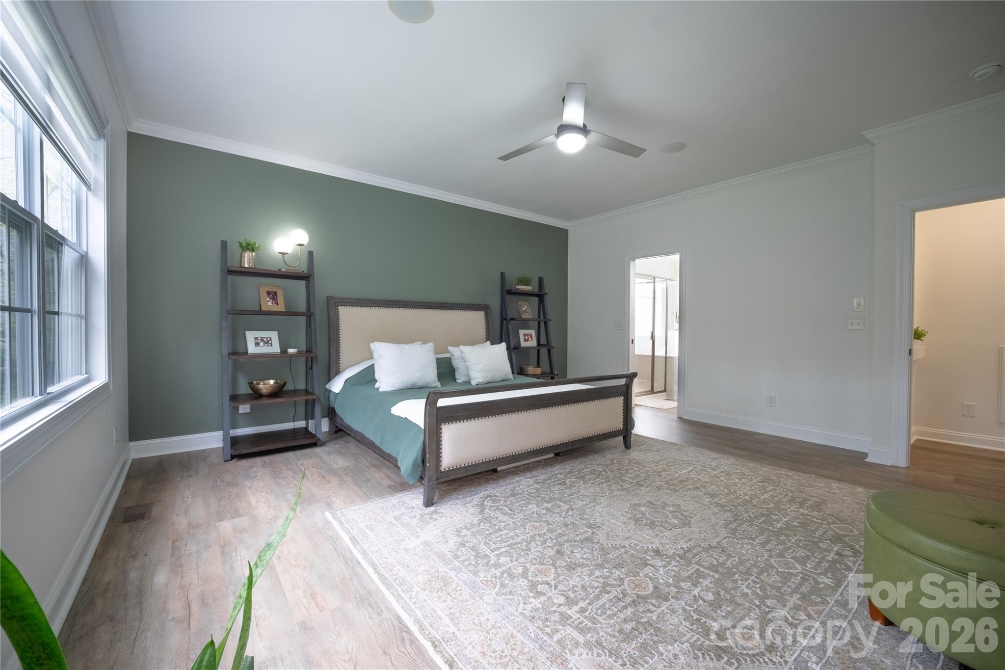 12058 Pelican Court Tega Cay, SC 29708 - Photo 13 of 43 a spacious bedroom with a bed and a chandelier