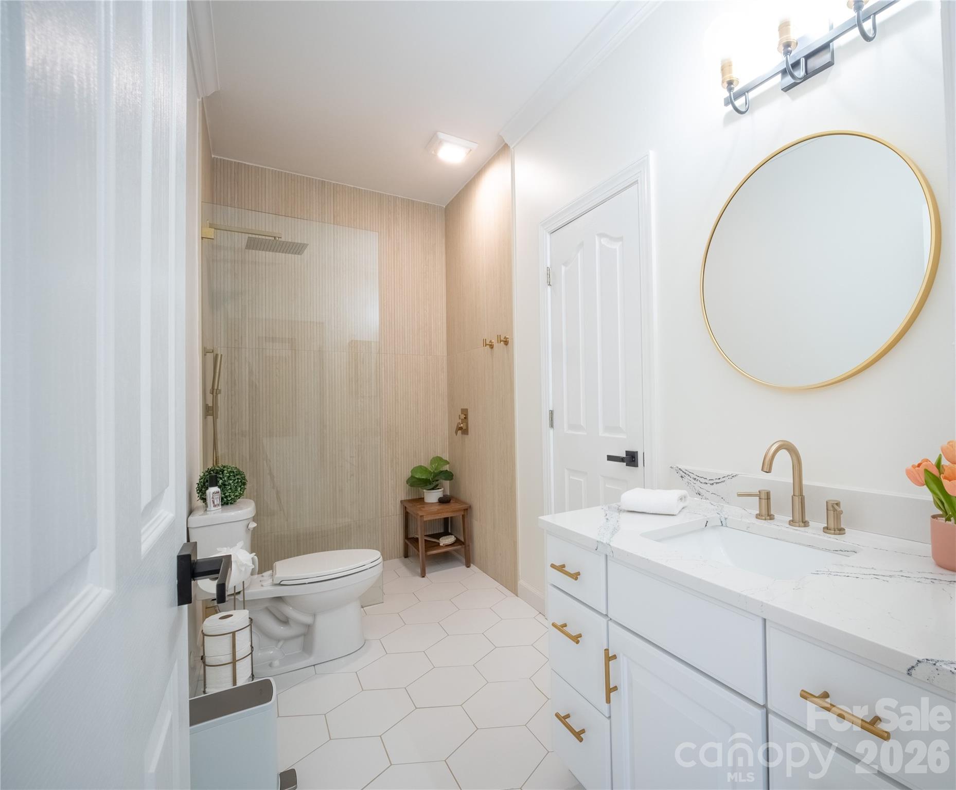 12058 Pelican Court Tega Cay, SC 29708 - Photo 19 of 43 a bathroom with a toilet a sink and mirror