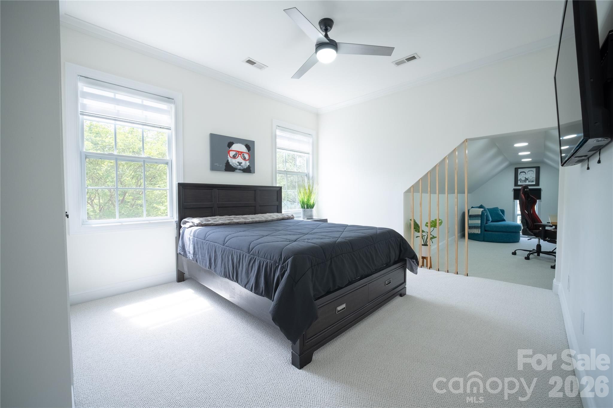 12058 Pelican Court Tega Cay, SC 29708 - Photo 26 of 43 a spacious bedroom with a bed a couch and a window