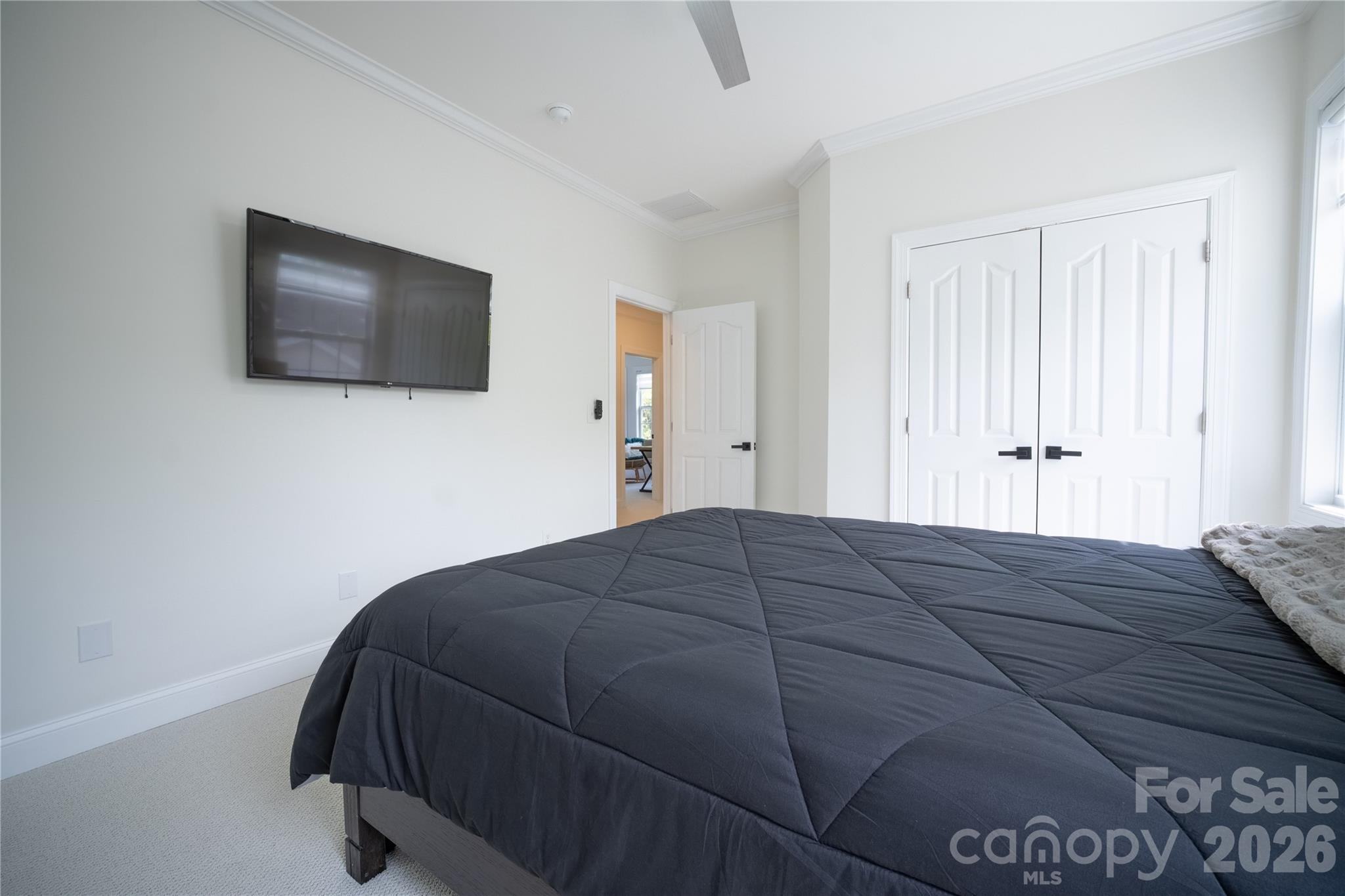 12058 Pelican Court Tega Cay, SC 29708 - Photo 27 of 43 a bedroom with a bed and a flat screen tv