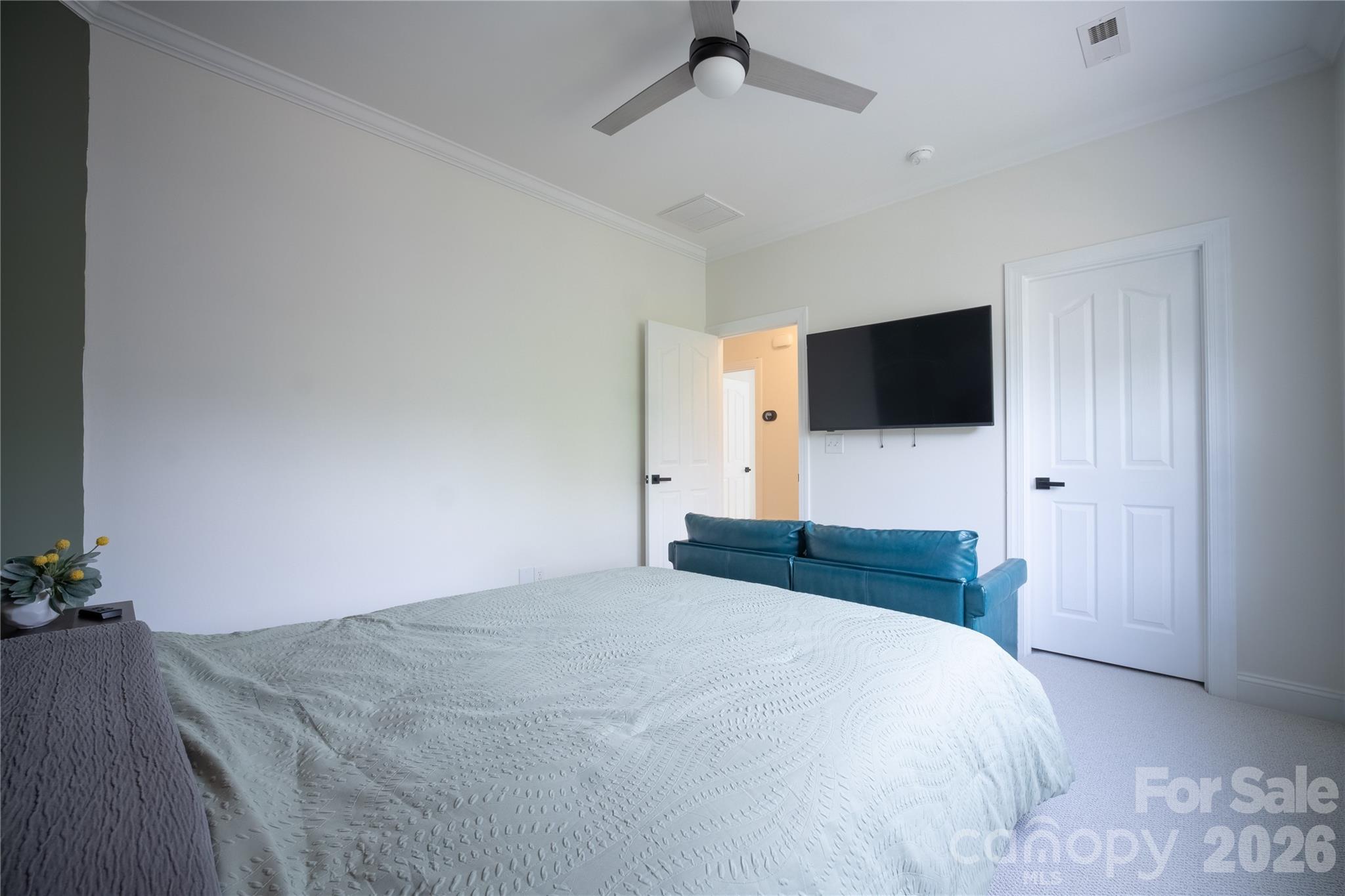 12058 Pelican Court Tega Cay, SC 29708 - Photo 31 of 43 a bedroom with a bed and a flat tv screen on the dresser