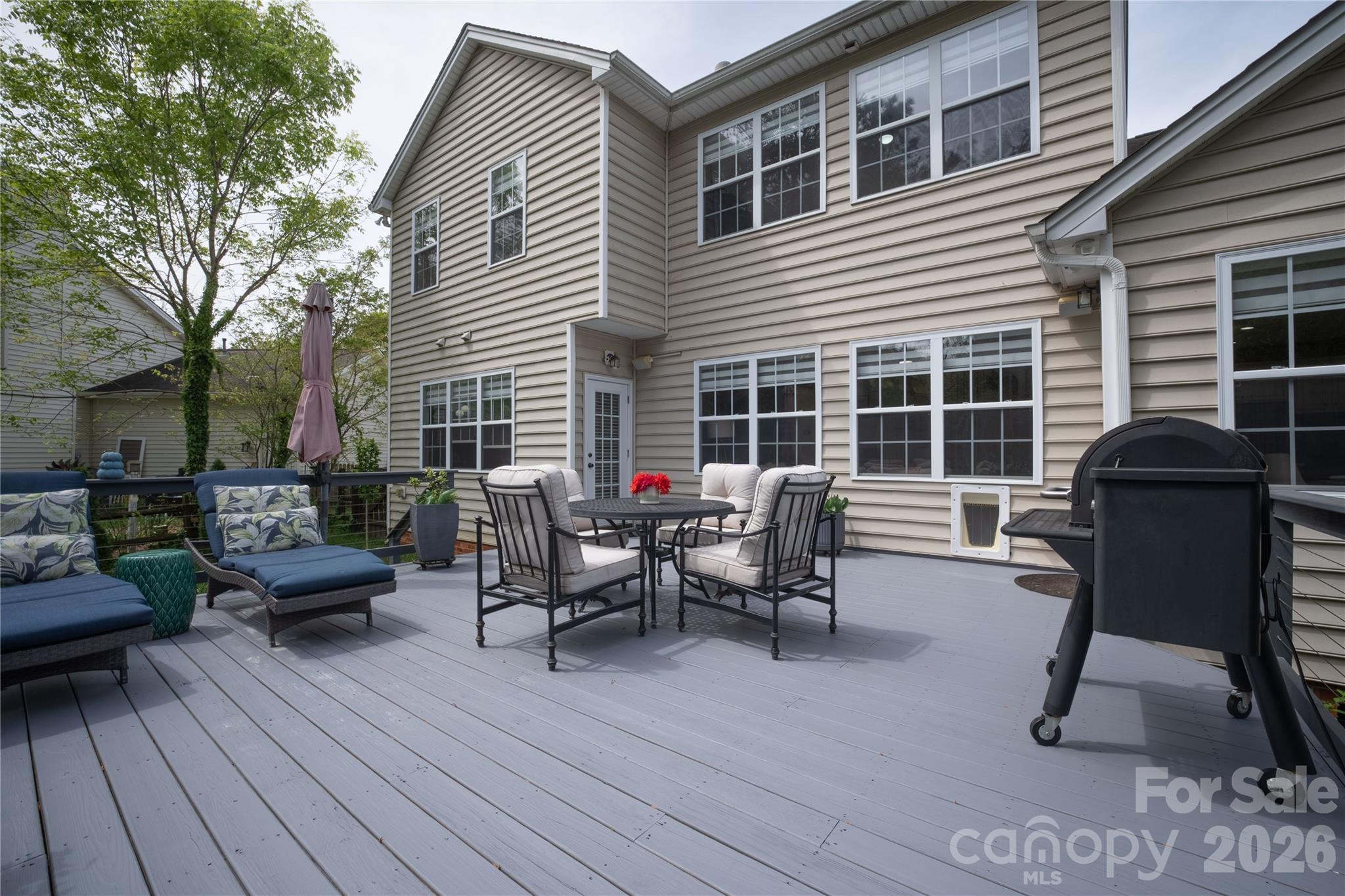 12058 Pelican Court Tega Cay, SC 29708 - Photo 36 of 43 a view of a chairs and table in the back yard of the house