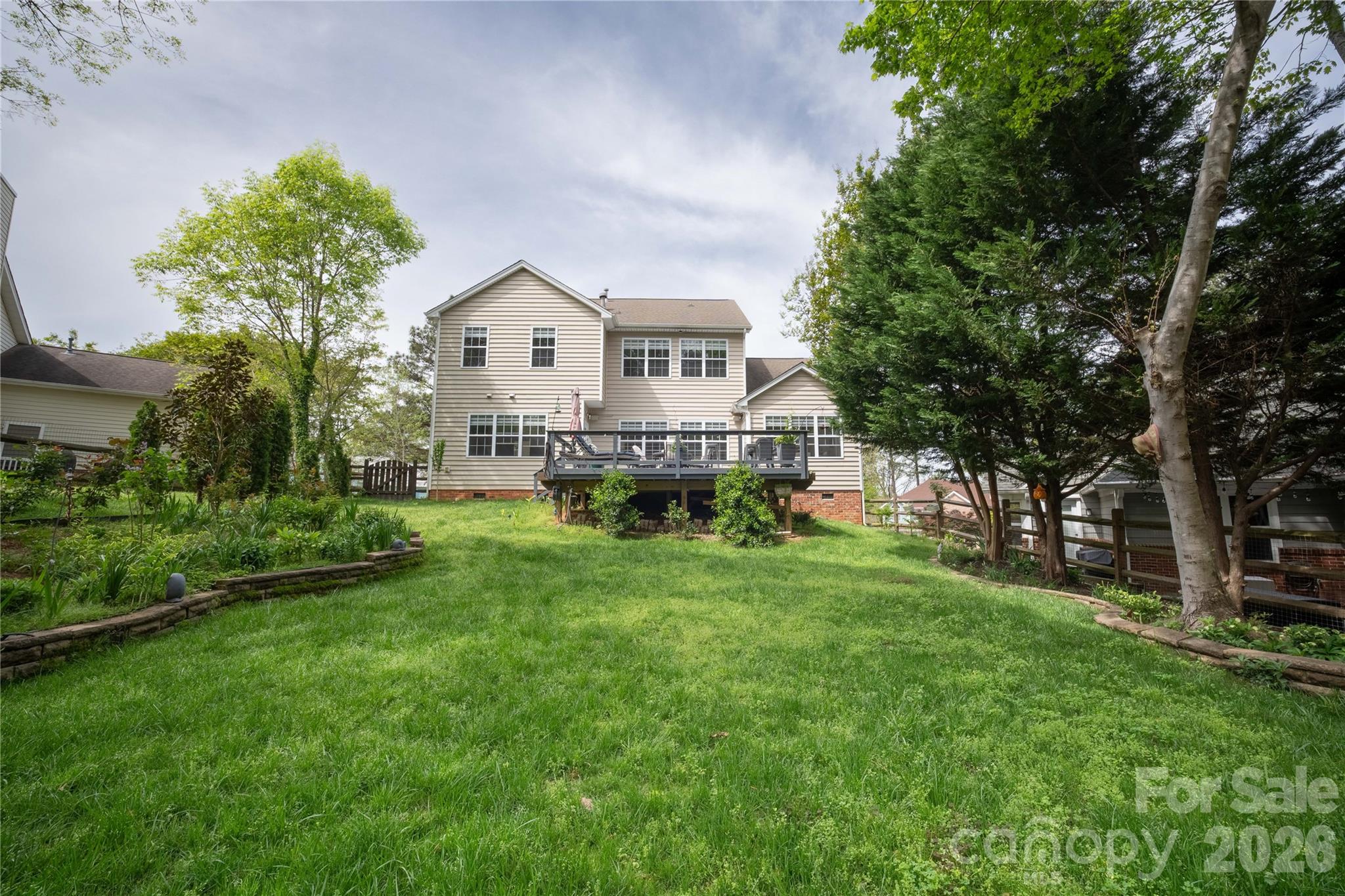 12058 Pelican Court Tega Cay, SC 29708 - Photo 39 of 43 a front view of a house with a garden and trees