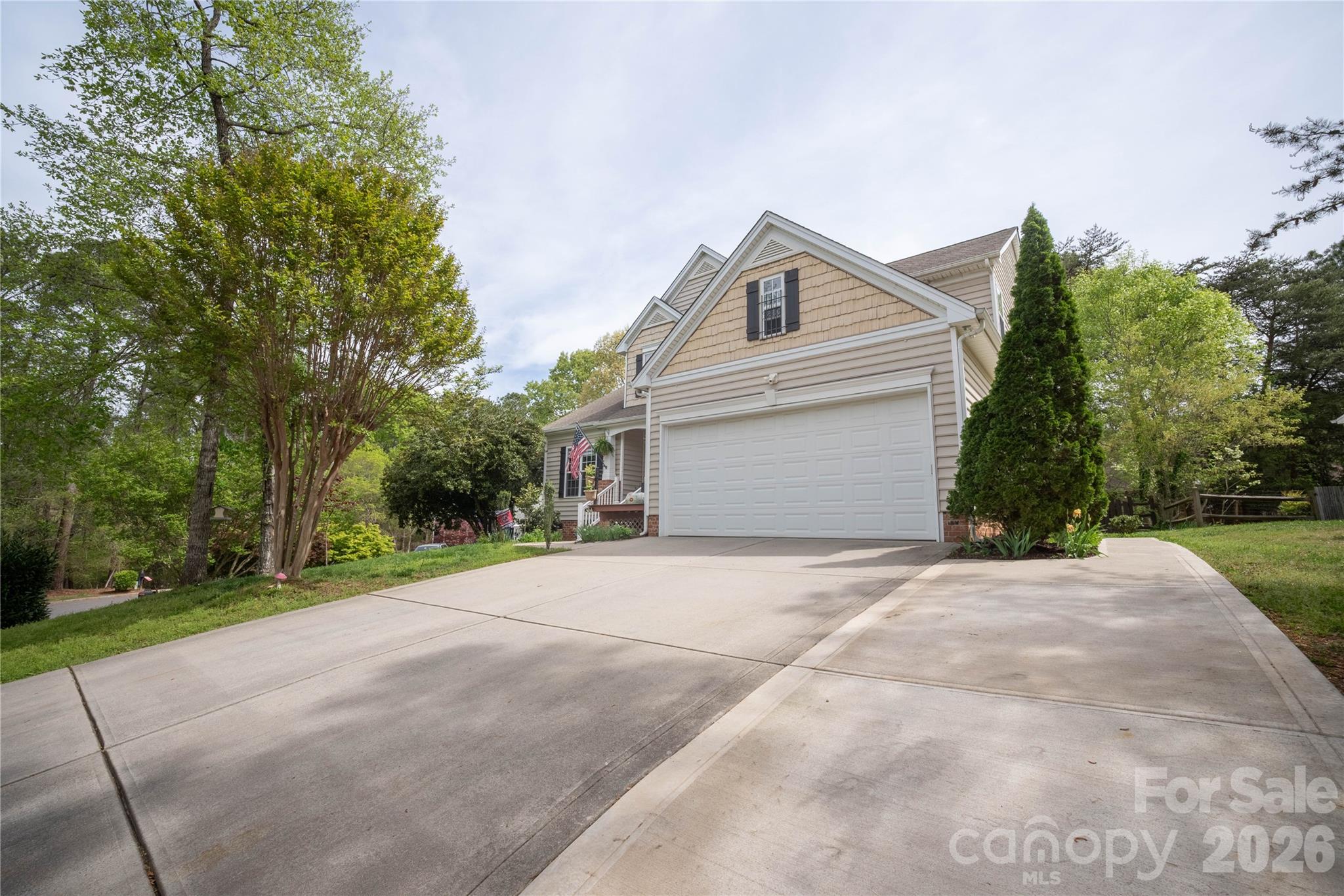 12058 Pelican Court Tega Cay, SC 29708 - Photo 40 of 43 a backyard of a house with large trees and plants