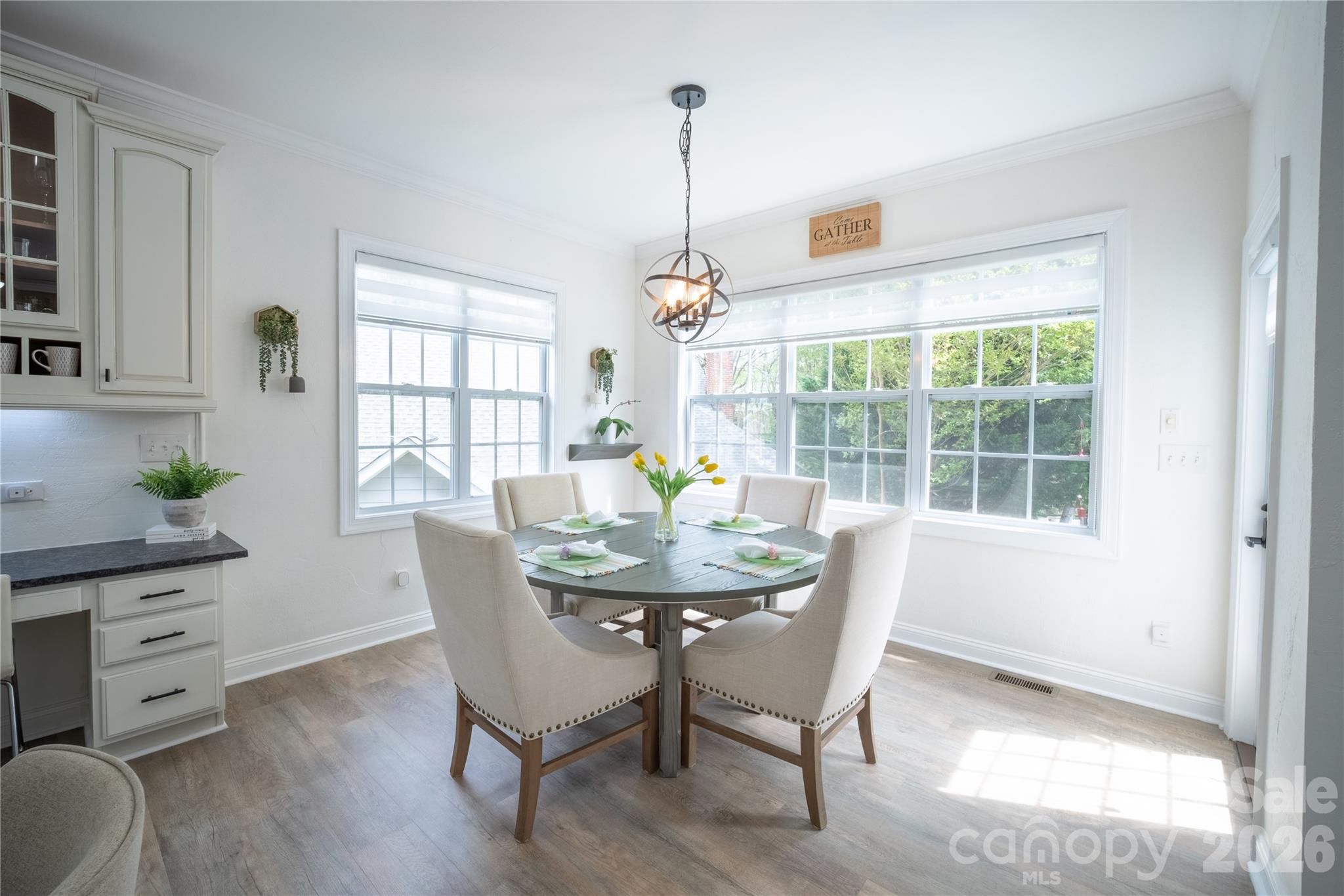12058 Pelican Court Tega Cay, SC 29708 - Photo 10 of 43 a dining room with furniture a chandelier and wooden floor