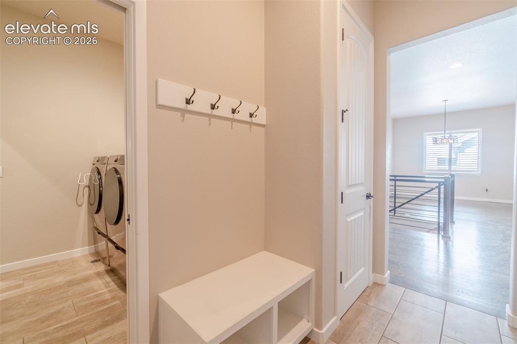 1061 Native Dancer Terrace Colorado Springs, CO 80921 - Photo 20 of 50 Entryway featuring tiled flooring, built-in bench with storage, and coat hooks
