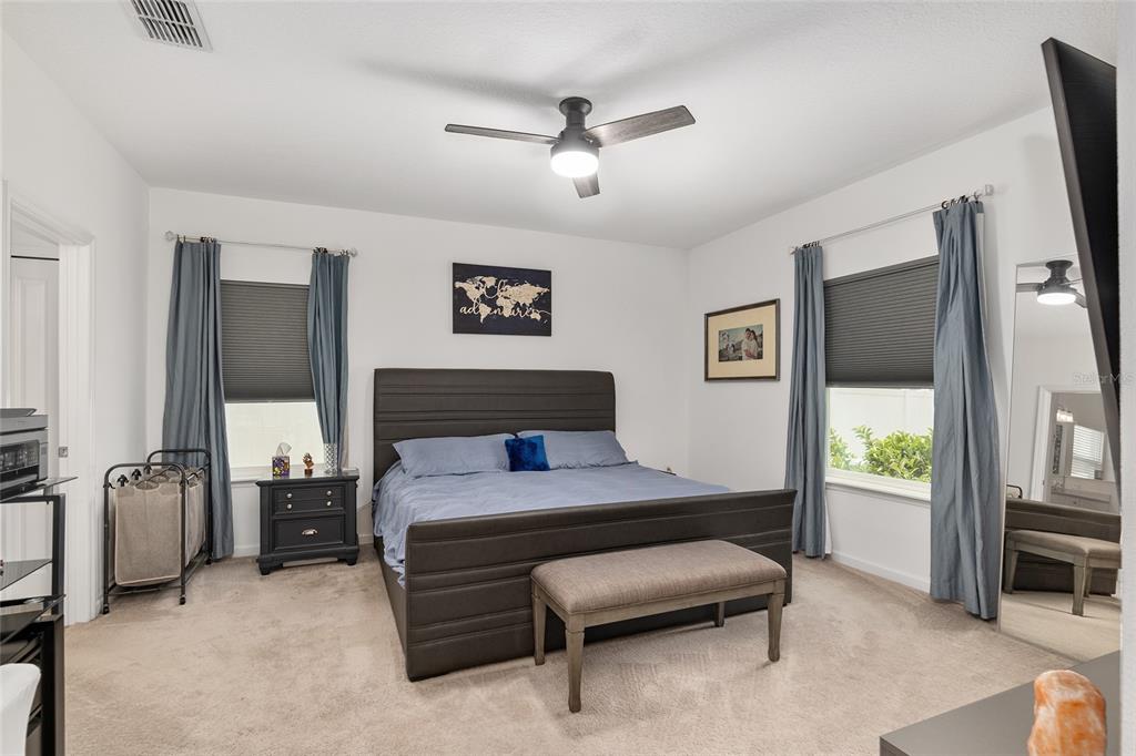 5688 Southwest 92nd Place Ocala, FL 34476 - Photo 26 of 54 a bedroom with a bed and a chandelier