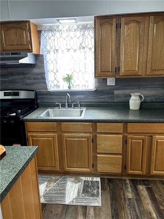 512 Lowell Street Vandergrift, PA 15690 - Photo 15 of 32 a kitchen with granite countertop a sink a stove and cabinets