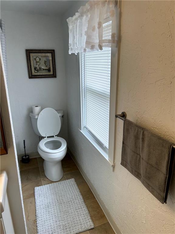 512 Lowell Street Vandergrift, PA 15690 - Photo 24 of 32 a white toilet sitting next to a bathroom sink