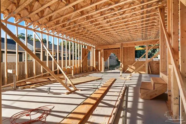 a view of a hall with wooden floor and furniture