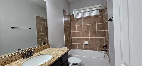 a bathroom with a bathtub and shower