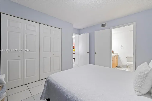 a bedroom with a bed and cabinets