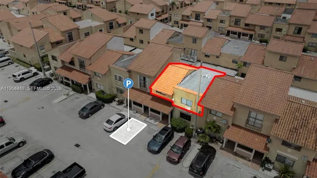 an aerial view of residential houses with outdoor space