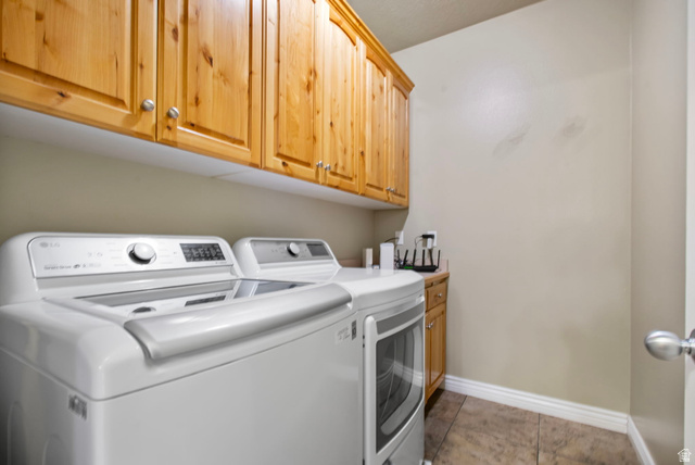 557 South 1470th Street East Springville, UT 84663 - Photo 21 of 46 Laundry room with cabinet space, washer and dryer, and light tile patterned floors