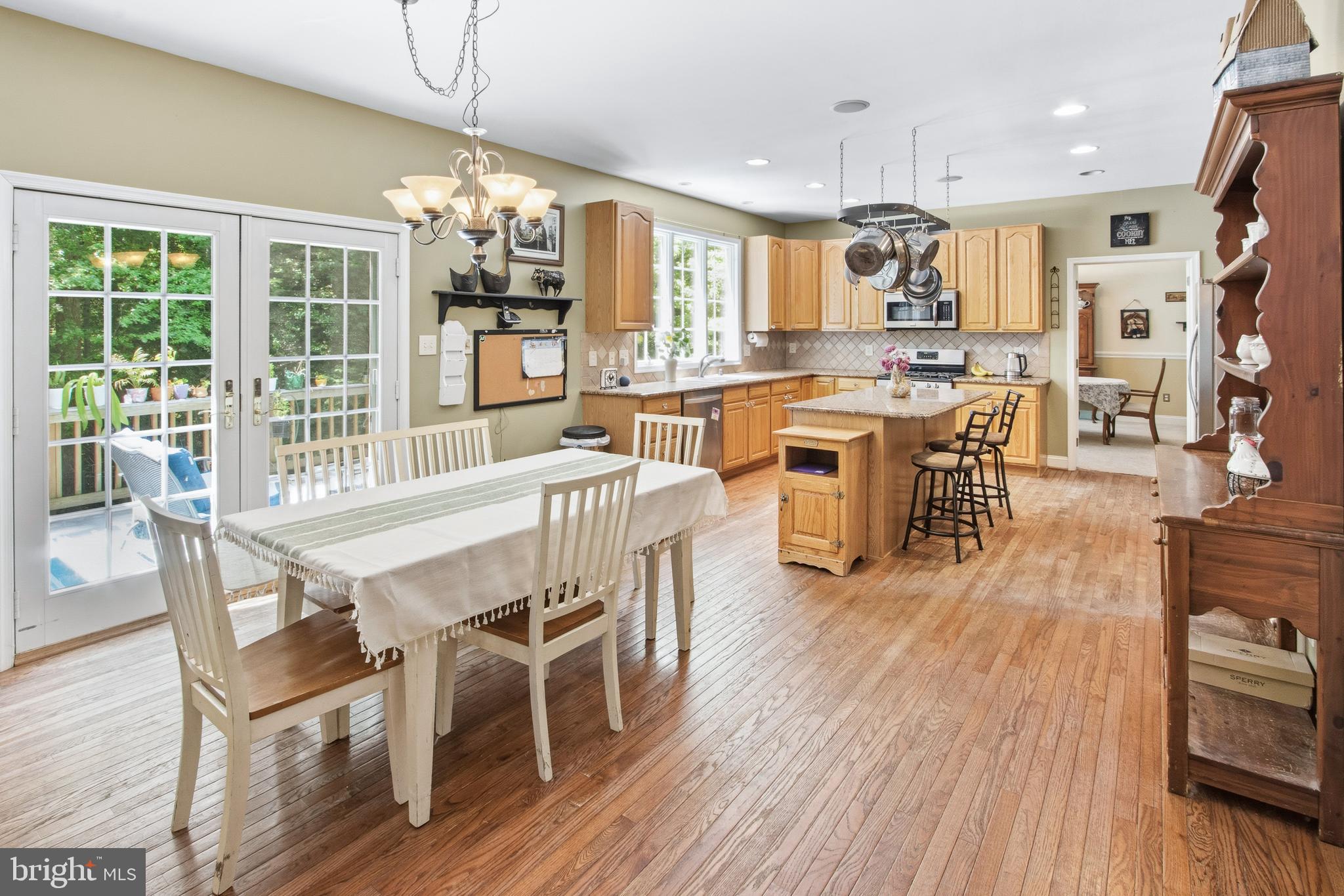 15 Hollybrook Road Mullica Hill, NJ 08062 - Photo 3 of 38 a view of a dining room and livingroom with furniture wooden floor a chandelier