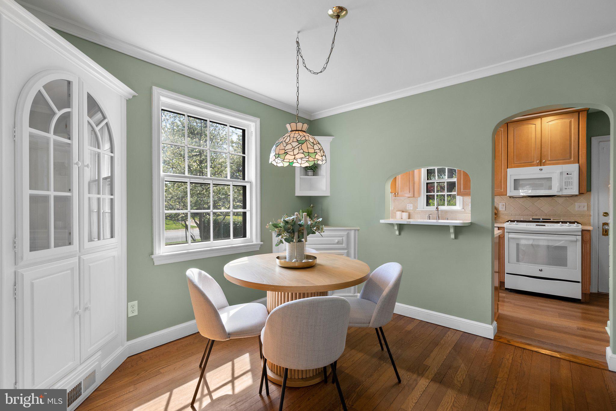 10210 Pierce Drive Silver Spring, MD 20901 - Photo 11 of 49 a dining room with furniture a window and wooden floor