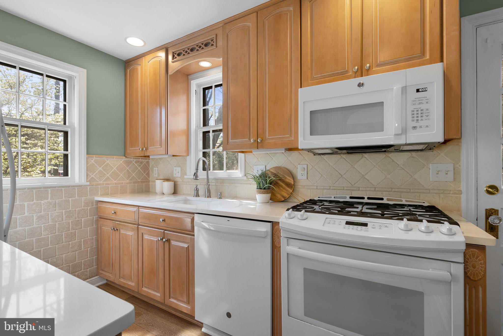 10210 Pierce Drive Silver Spring, MD 20901 - Photo 14 of 49 a kitchen with granite countertop a stove sink and cabinets