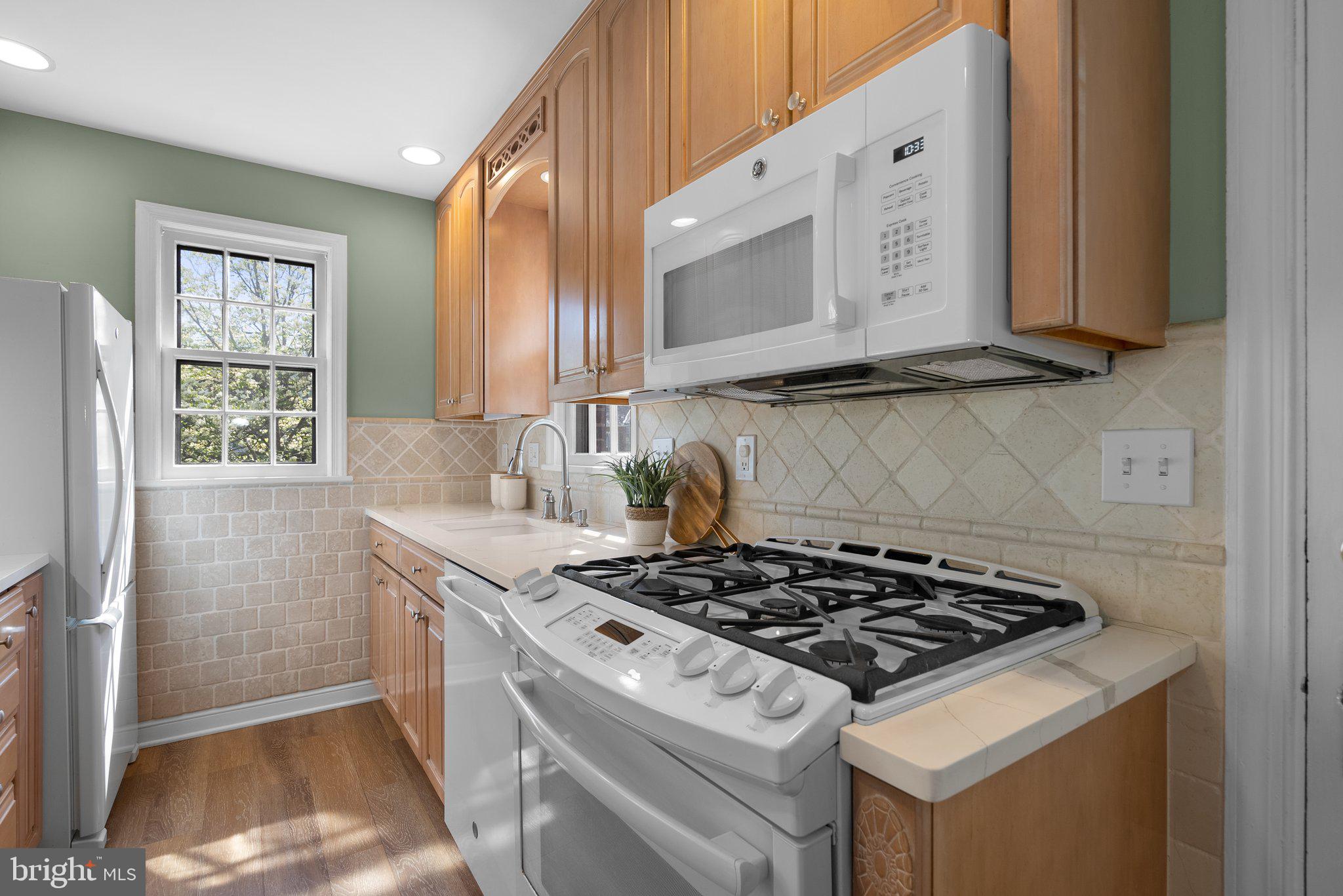 10210 Pierce Drive Silver Spring, MD 20901 - Photo 15 of 49 a kitchen with stove a sink and a window