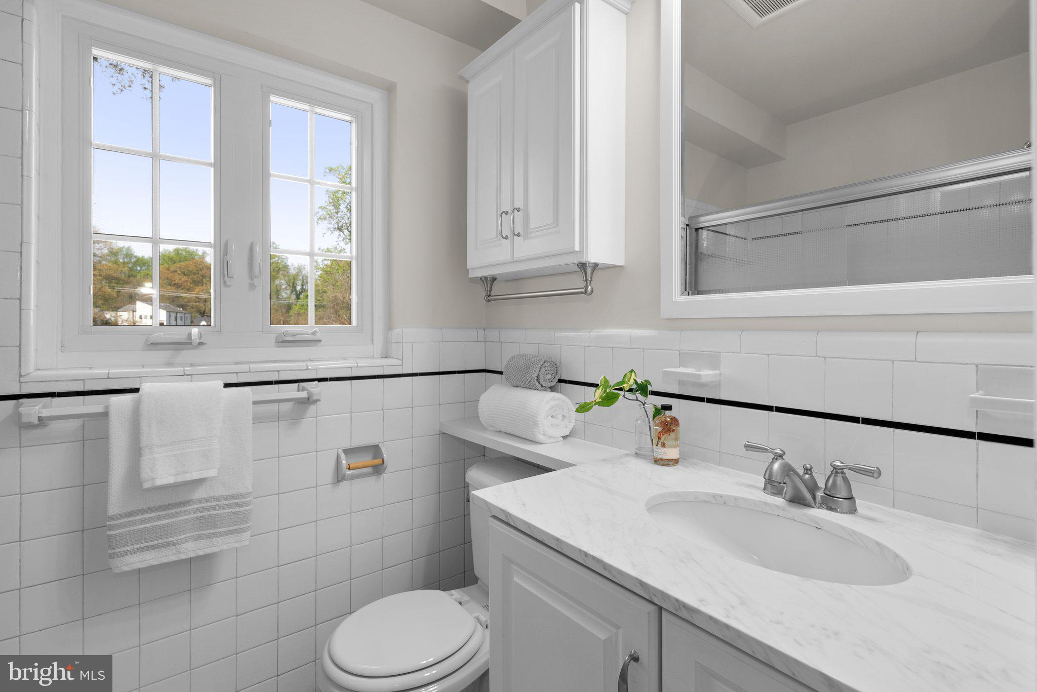 10210 Pierce Drive Silver Spring, MD 20901 - Photo 18 of 49 a bathroom with a sink toilet and window