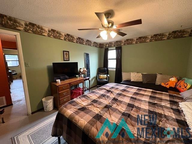 1037 Oakhurst Road Clovis, NM 88101 - Photo 7 of 21 Room featuring light green walls, a neutral ceiling, and a ceiling fan with integrated lighting