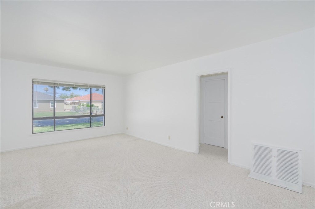 13792 Figueroa Street Garden Grove, CA 92843 - Photo 2 of 38 an empty room with wooden floor and windows