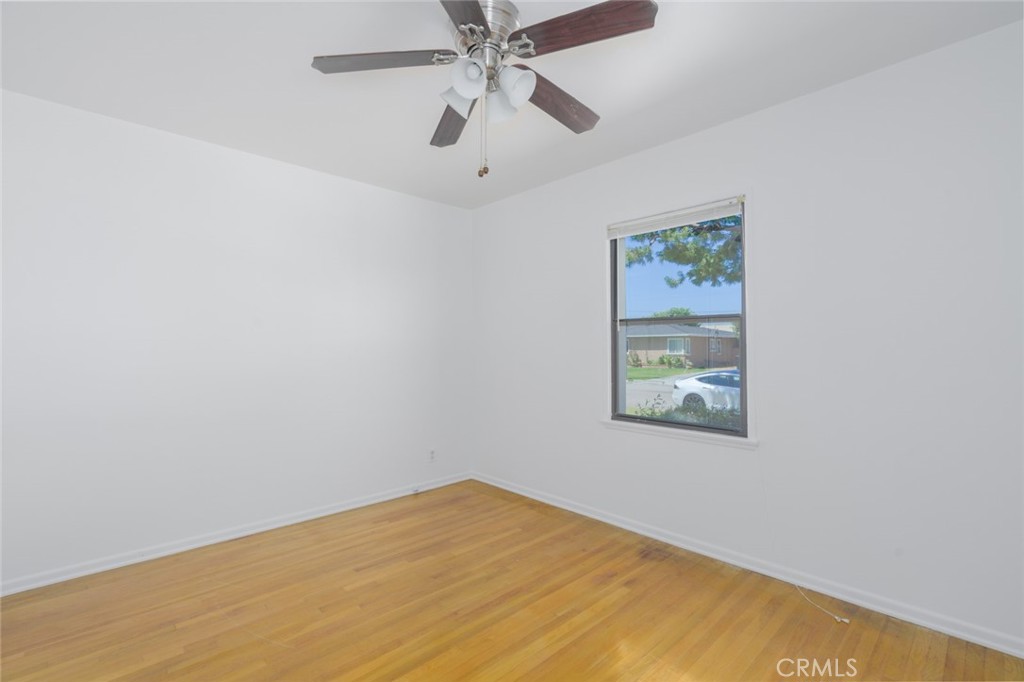 13792 Figueroa Street Garden Grove, CA 92843 - Photo 21 of 38 an empty room with a window and a fan