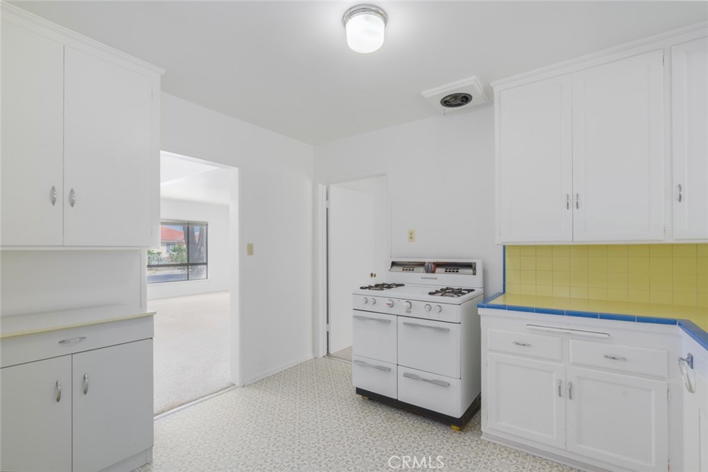 13792 Figueroa Street Garden Grove, CA 92843 - Photo 9 of 38 a kitchen with white cabinets and white appliances