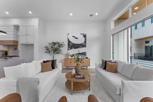 a kitchen with stainless steel appliances a stove and white cabinets