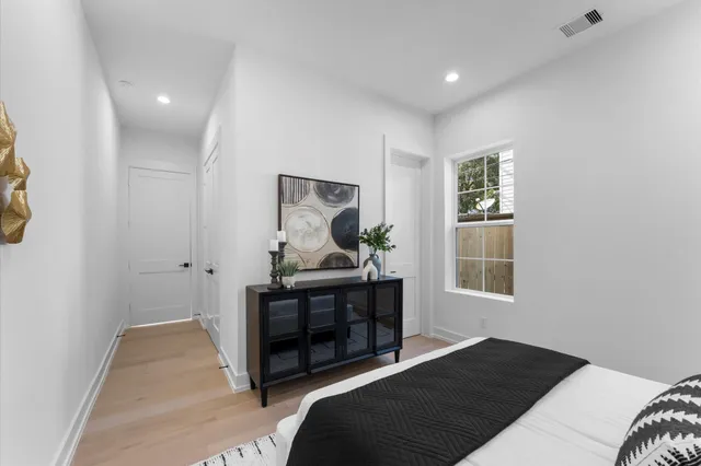 a bedroom with a bed and wooden floor