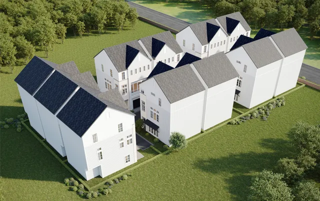 an aerial view of a house with outdoor space and a lake view