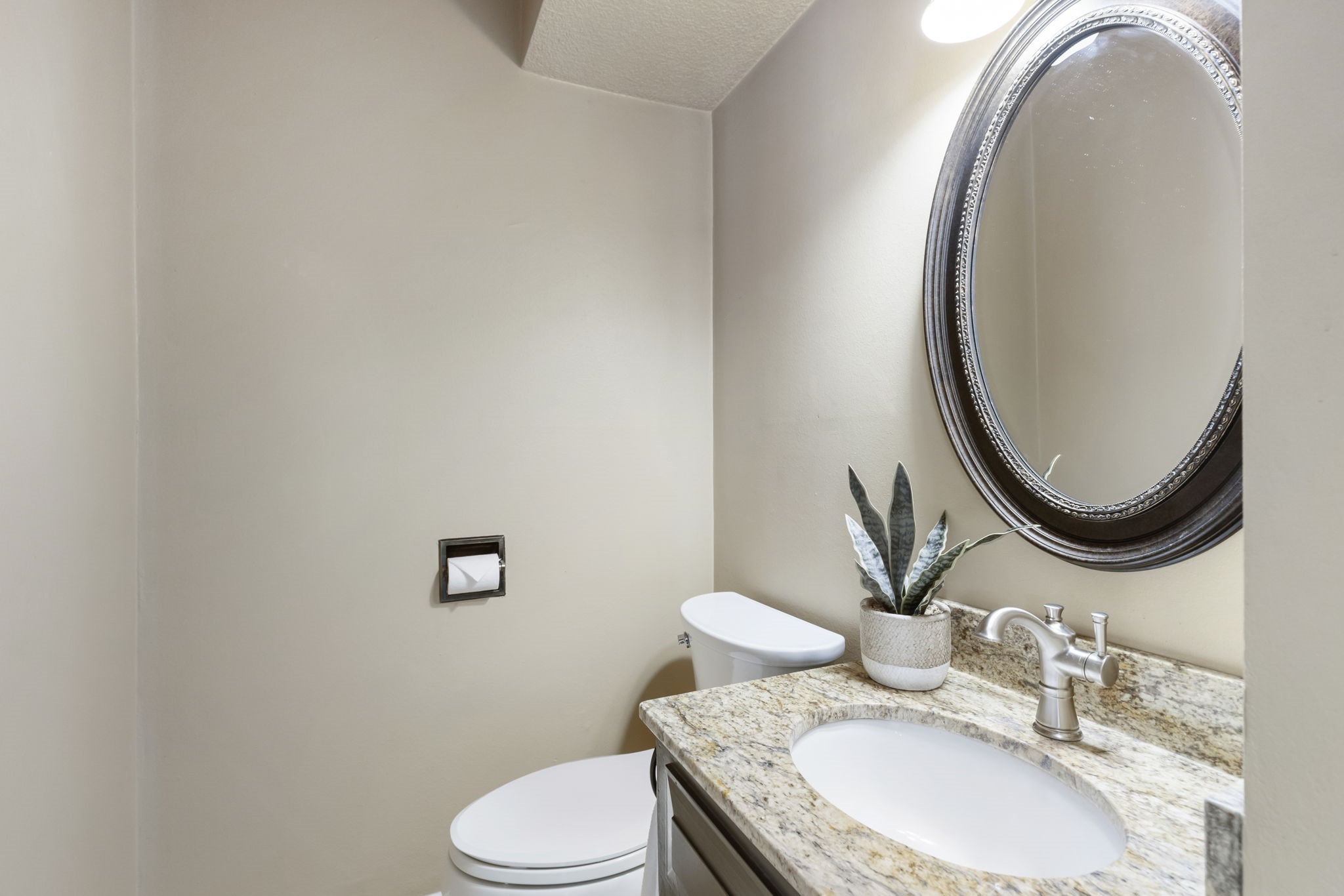 6414 Hickorycrest Drive Spring, TX 77389 - Photo 19 of 49 a bathroom with a granite countertop toilet a sink and a mirror