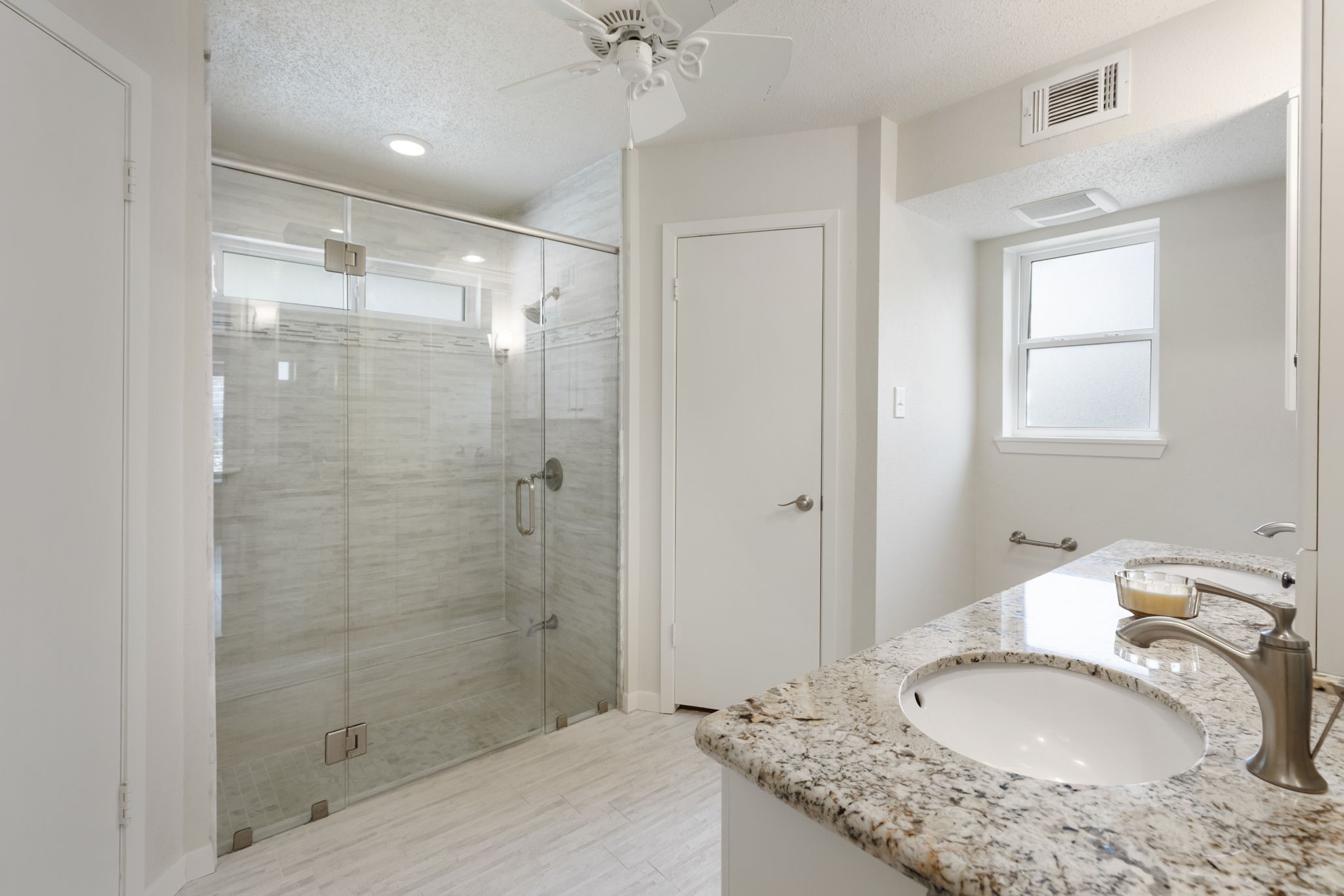 6414 Hickorycrest Drive Spring, TX 77389 - Photo 22 of 49 a bathroom with a granite countertop sink a mirror and a shower