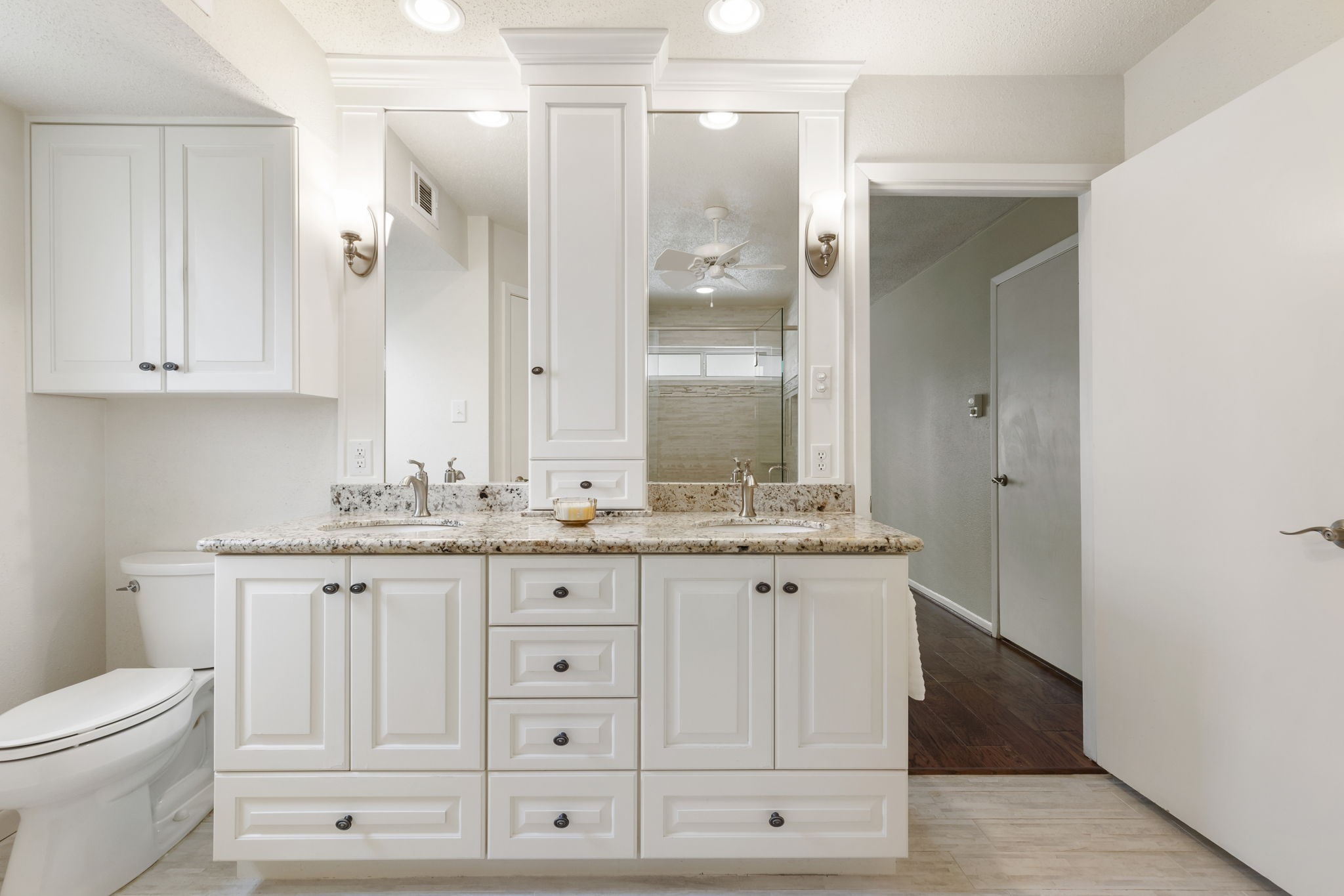 6414 Hickorycrest Drive Spring, TX 77389 - Photo 24 of 49 a bathroom with a granite countertop toilet a sink and a mirror