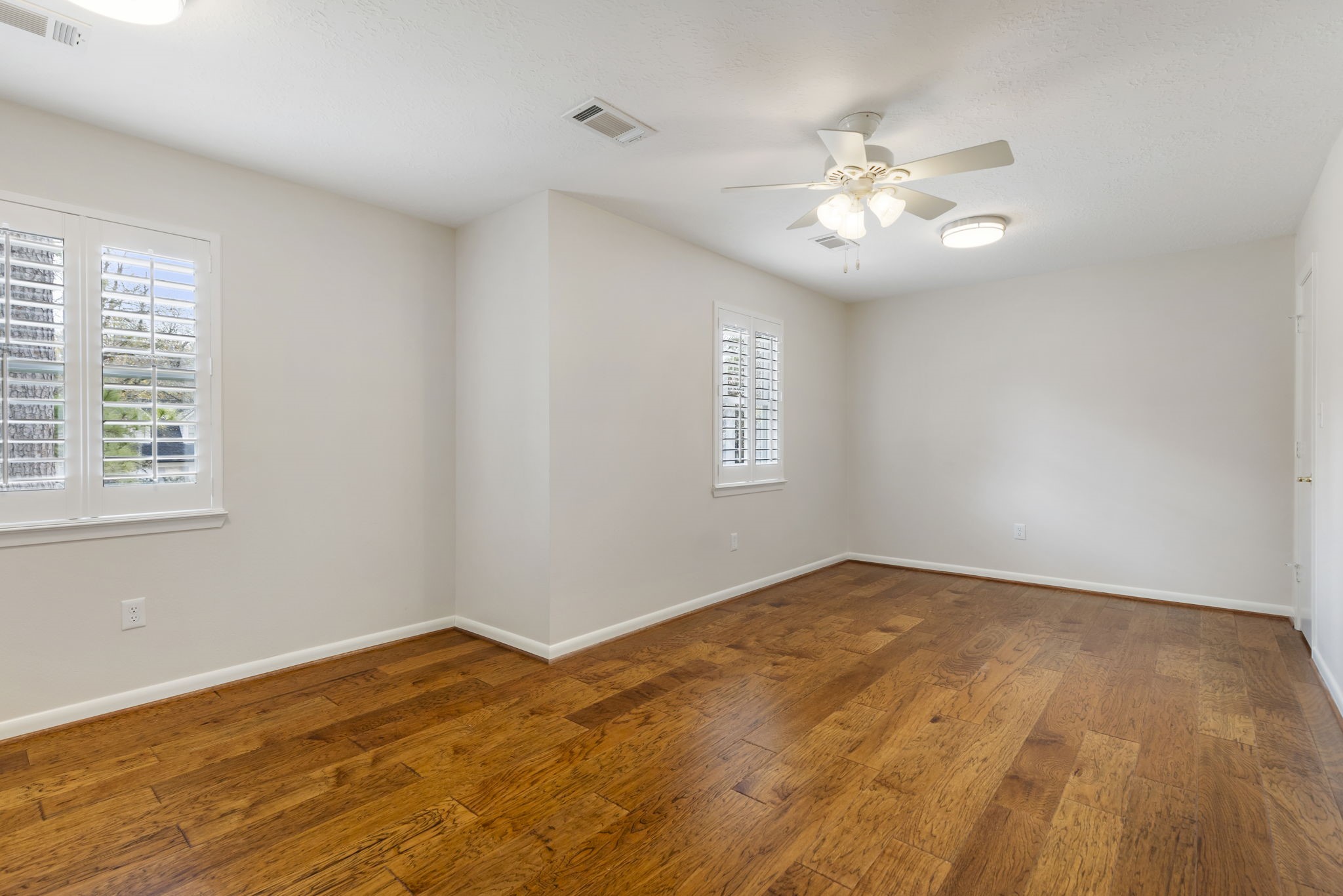 6414 Hickorycrest Drive Spring, TX 77389 - Photo 31 of 49 a view of an empty room with wooden floor and a window