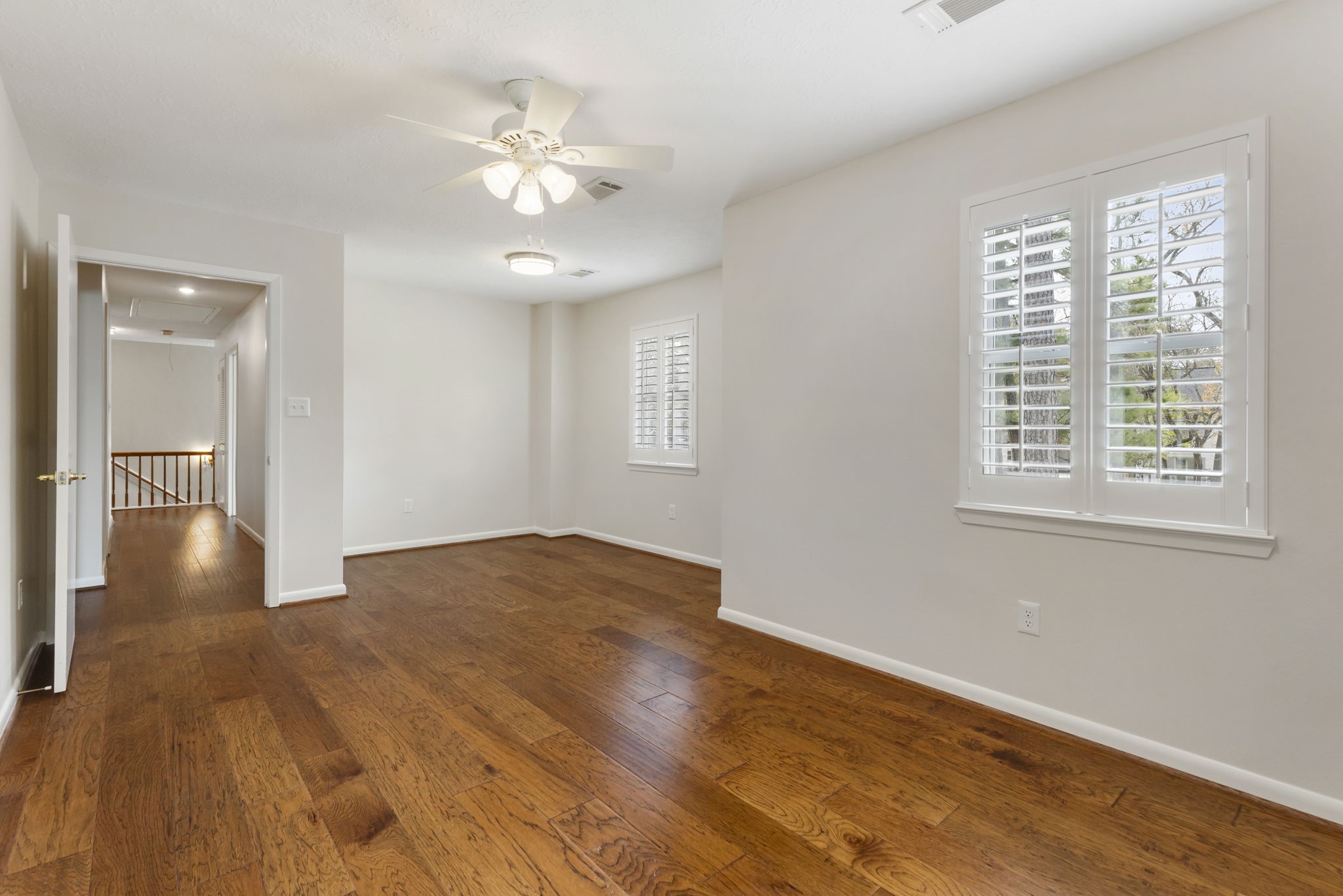 6414 Hickorycrest Drive Spring, TX 77389 - Photo 32 of 49 a view of an empty room with wooden floor and a window
