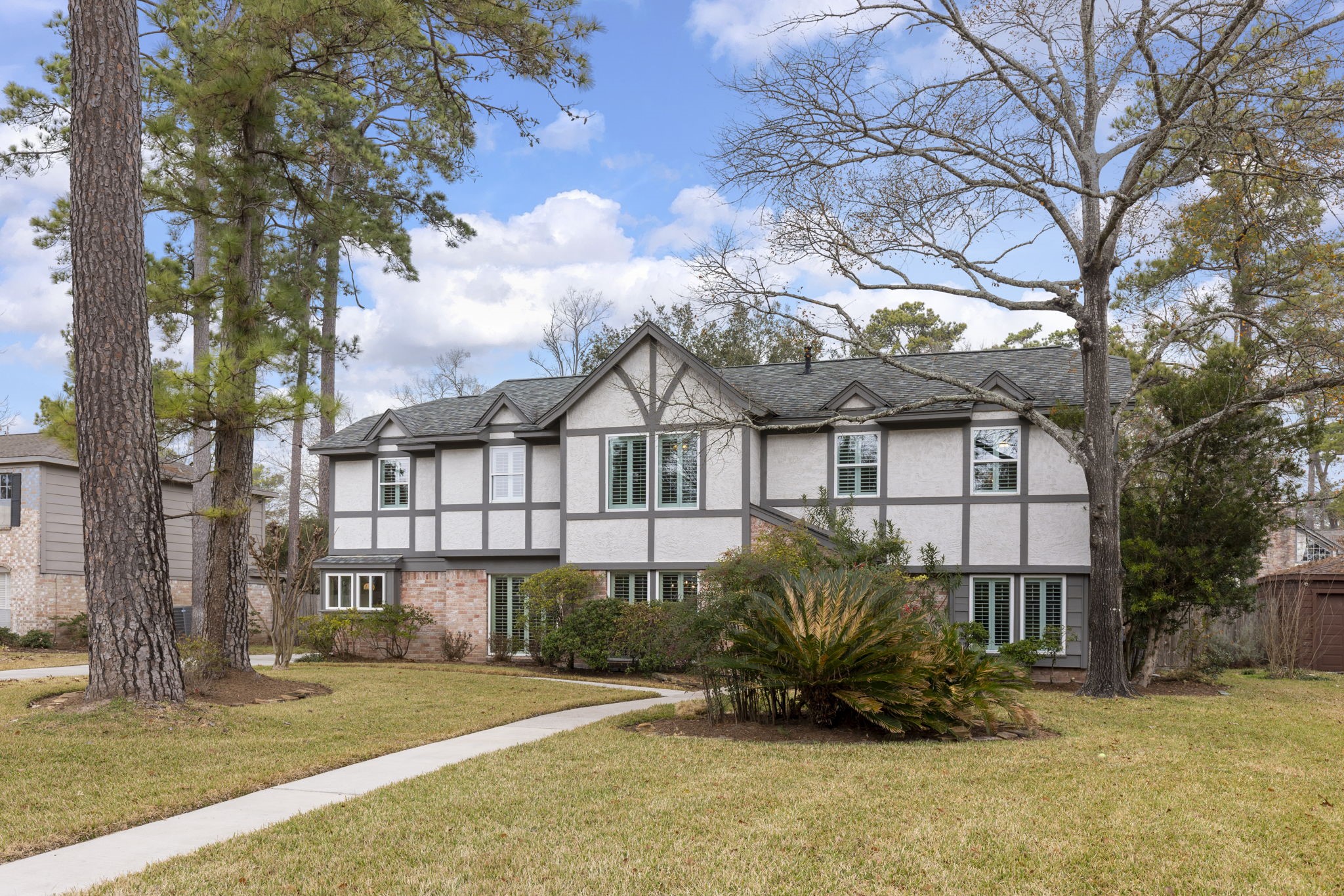 6414 Hickorycrest Drive Spring, TX 77389 - Photo 49 of 49 a view of a white house with a large tree and wooden fence