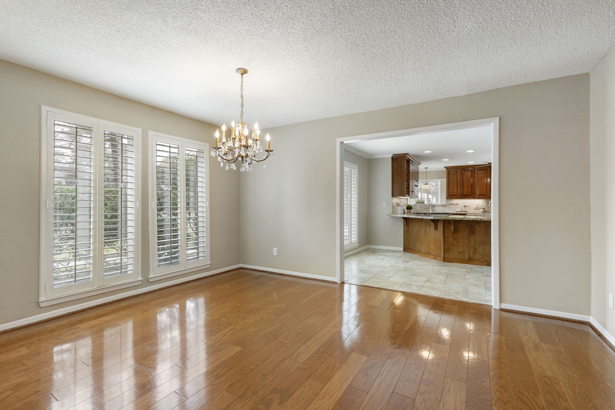 6414 Hickorycrest Drive Spring, TX 77389 - Photo 8 of 49 This spacious dining area has hardwood floors and large windows with shutters providing natural light. It seamlessly connects to the kitchen.