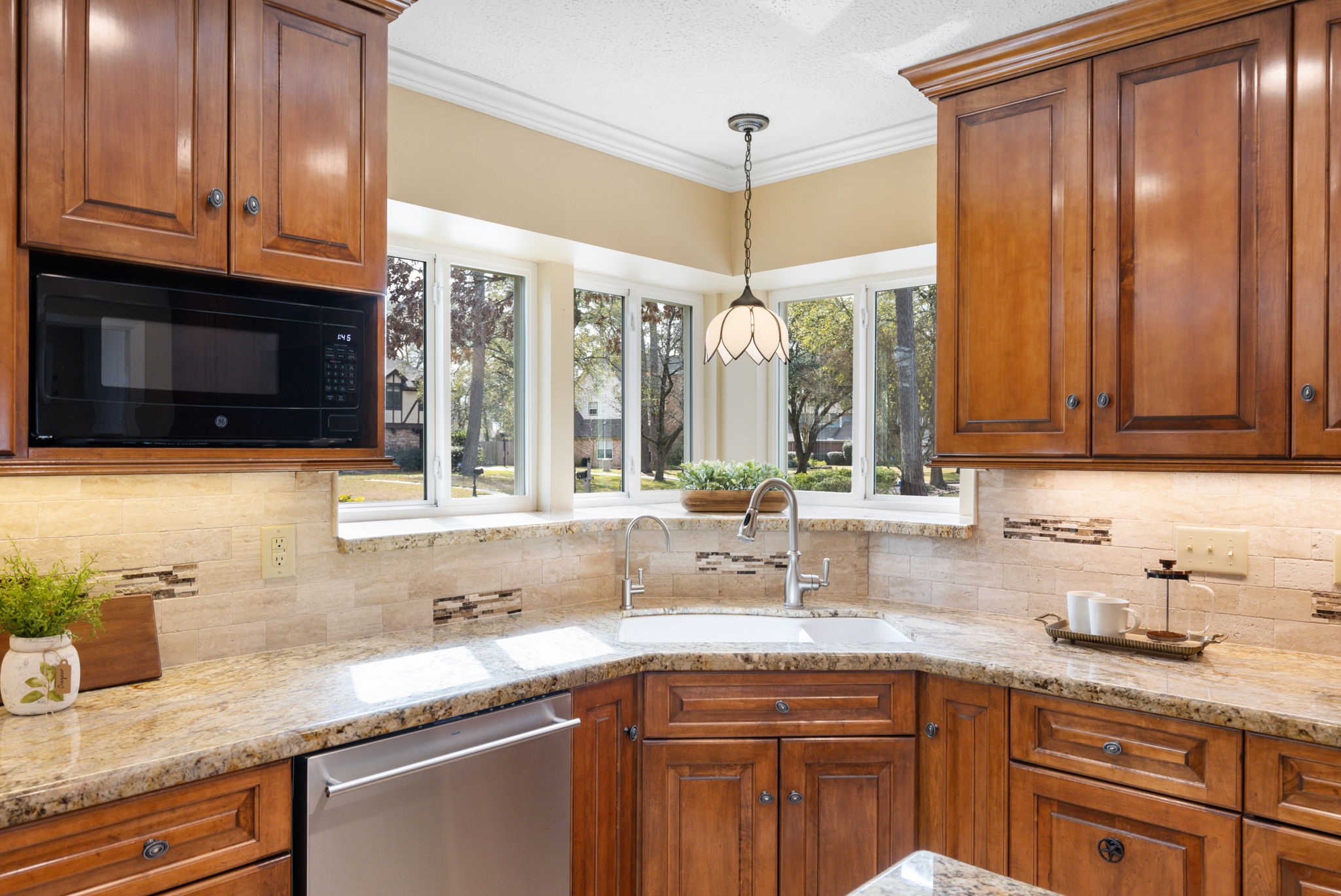 6414 Hickorycrest Drive Spring, TX 77389 - Photo 10 of 49 a kitchen with granite countertop stainless steel appliances a sink window and cabinets