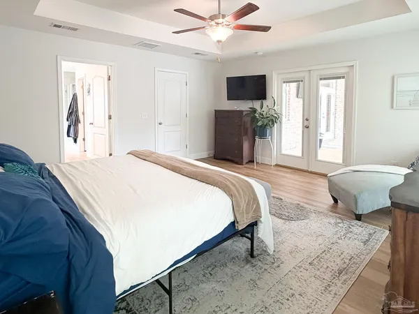 a bedroom with a bed and a television
