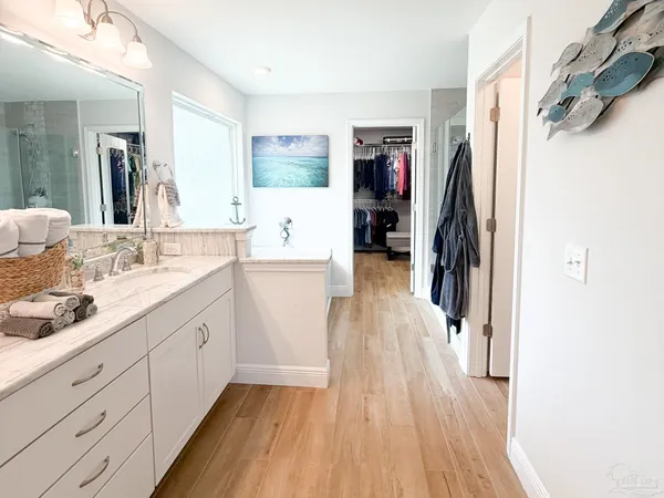 a bathroom with a sink a mirror and a shower