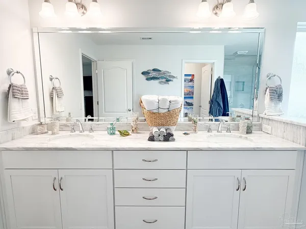 a bathroom with double sink and a mirror