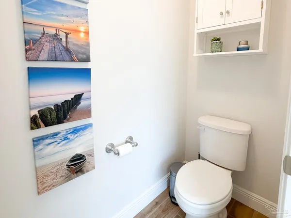 a white toilet sitting next to a bathroom sink