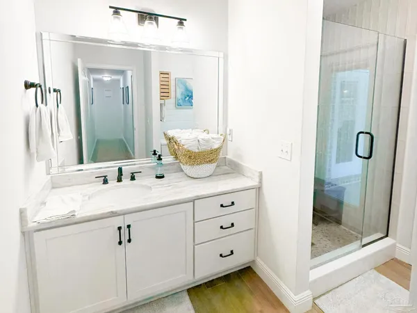 a bathroom with a granite countertop sink mirror and shower